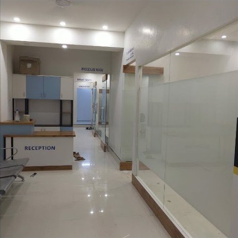 Reception desk at Chaturvedi Dental Clinic with signage for the procedure room and implant area
